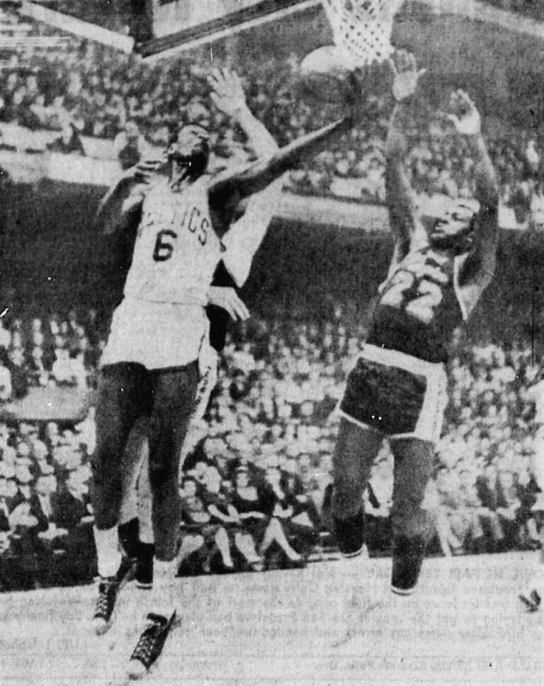 Boston Celtics center Bill Russell (left, number 6) attempts a layup as Los Angeles Lakers forward Elgin Baylor defends (right, number 22) during the second game of the 1963 NBA Finals on April 16, 1963.